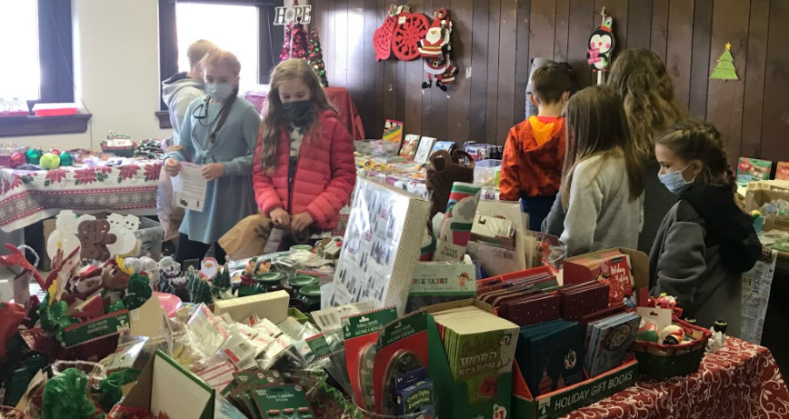 kids looking at tables full of stuff